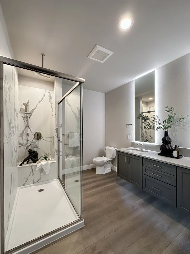 White sleek bathroom renovated by Custom Cabinets