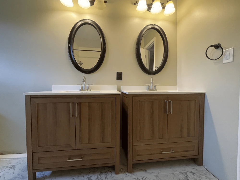 Expert bathroom remodeling in Aurora with wood cabinetry and marble flooring